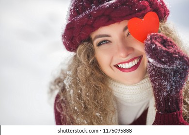 Portrait Of Young Attractive Woman Outdoors In Winter Time Showing The Paper Heart