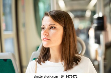 Portrait Of Young Attractive Woman Traveling In Modern Streetcar