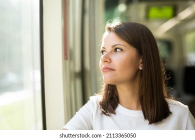 Portrait Of Young Attractive Woman Traveling In Modern Streetcar