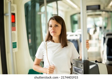 Portrait Of Young Attractive Woman Traveling In Modern Streetcar