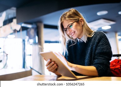 Portrait of young attractive woman using tablet - Powered by Shutterstock