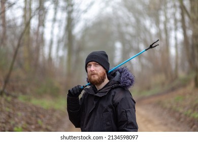 A Portrait Of A Young Bearded Man With A Litter Picker And A Bucket Ready To Do A Litter Pick And Clean Up The Countryside. Litter Pick, Rubbish, Environmental Concept