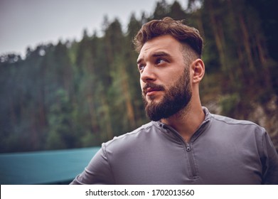 Portrait Of A Young, Bearded Man, On, Against A Background Of Wildlife. The Concept Of Expedition, Adventure And Camping Life