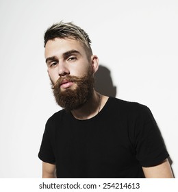 Portrait of a young bearded man on a white background