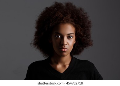 Portrait Of Young Beautiful African Girl  Over Dark Background.