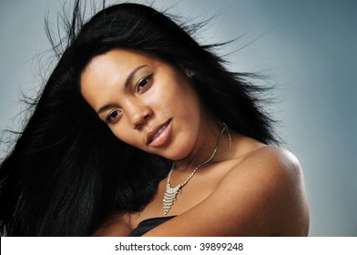 Portrait Of Young Beautiful African Hispanic Woman With Long Hair