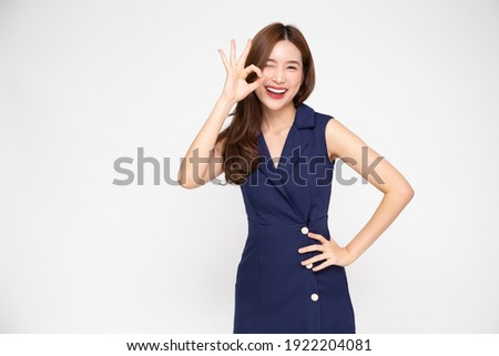 Portrait of Young beautiful Asian businesswoman smiling and showing ok sign on hand isolated on white background, Looking at camera