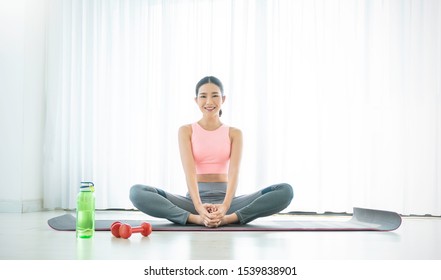 Portrait of young beautiful asian korean woman warm up exercise workout yoga position at home living room. Sporty girl health care lifestyle. Yoga for beginner, asian wellbeing, healthy quarantine.
