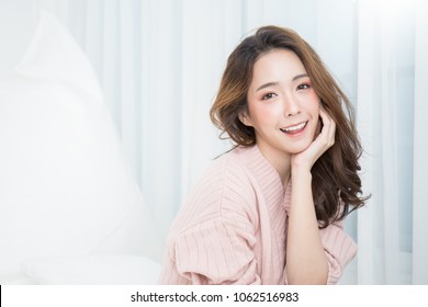 Portrait of young beautiful asian woman relax face in winter bedroom. Sexy beauty girl with healthy makeup facial treatment perfect glow skin. Smile happy asian korean girl isolated white background.