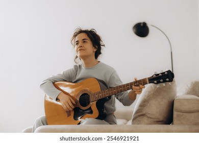 Portrait of young beautiful asian woman playing guitar music, sing and dance in bedroom. Smile happy asian girl relaxing knowledge education university woman lifestyle, back to school concept - Powered by Shutterstock