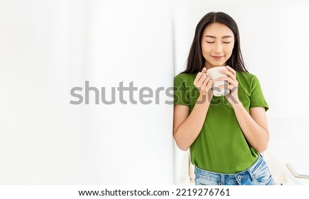 Portrait of young beautiful asian woman hands holding coffee cup morning spring time in white bedroom. Happy cheerful relaxing in summer. Korean makeup wakeup university asia lifestyle 