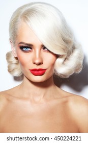 Portrait Of Young Beautiful Blonde Tanned Woman With Stylish Vintage Hairdo And Matte Red Lipstick