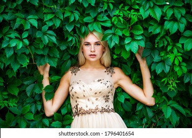 Portrait Of A Young Beautiful Blonde Woman In Ivy, Summer Park Outdoors