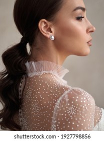 Portrait Of Young Beautiful Bride In White Wedding Dress With Brunette Hair In Pony Tail