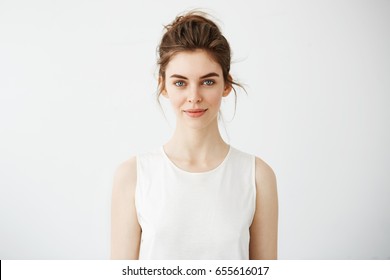 Portrait Of Young Beautiful Brunette Girl Smiling Looking At Camera Over White Background.