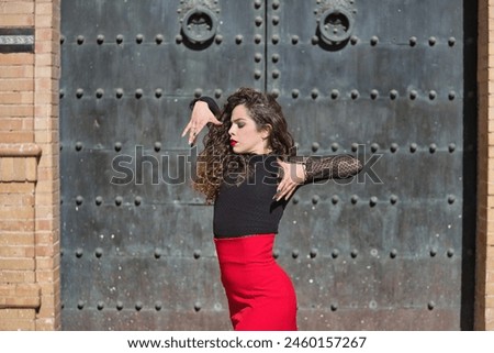 Beautiful young woman against a mirror wall