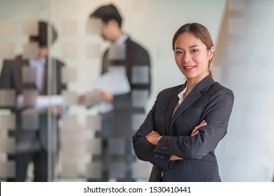 Portrait of young beautiful business woman in the office. Crossed arms - Shutterstock ID 1530410441