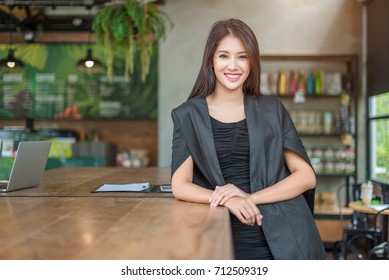 Portrait of young beautiful business woman in the coffee shop - Shutterstock ID 712509319