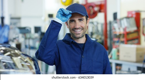 Portrait of a young beautiful car mechanic in a car workshop, in the background of service. Concept: repair of machines, fault diagnosis, repair specialist, technical maintenance and on-board computer - Powered by Shutterstock