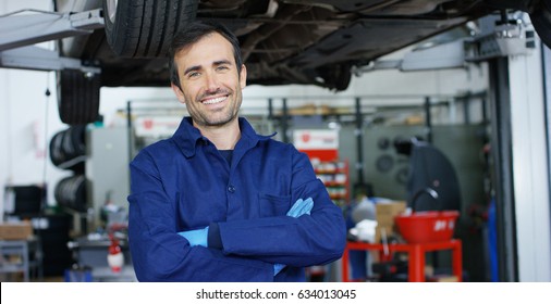 Portrait of a young beautiful car mechanic in a car workshop, in the background of service. Concept: repair of machines, fault diagnosis, repair specialist, technical maintenance and on-board computer - Shutterstock ID 634013045