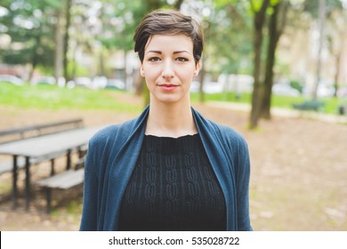 Portrait Of Young Beautiful Caucasian Brown Hair Woman Posing Outdoor In The City, Looking At Camera, Pensive - Serious, Melancholy, Serene Concept