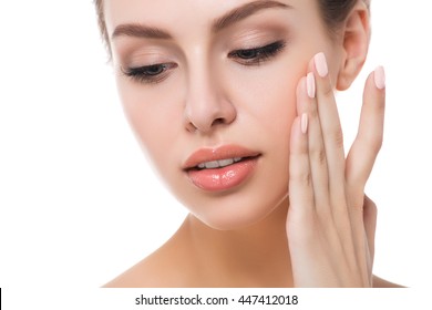 Portrait of young beautiful caucasian woman touching her face isolated over white background. Cleaning face, perfect skin. SPA therapy, skincare, cosmetology and plastic surgery concept