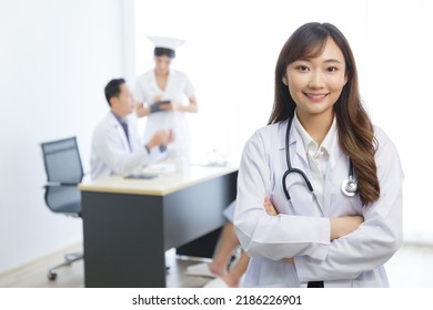 Portrait Of Young Beautiful Cheerful Female Doctor Smiling With Doctor Nurse And Patient Interaction Together On The Background