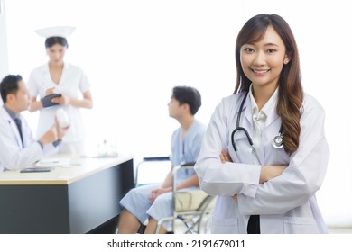 Portrait Of Young Beautiful Cheerful Female Doctor Smiling With Doctor Nurse And Patient Interaction Together On The Background