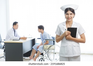 Portrait Of Young Beautiful Cheerful Female Nurse Smiling With Doctor Nurse And Patient Interaction Together On The Background. COPY SPACE.