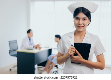 Portrait Of Young Beautiful Cheerful Nurse Smiling With Doctor And Patient Interaction Together Background