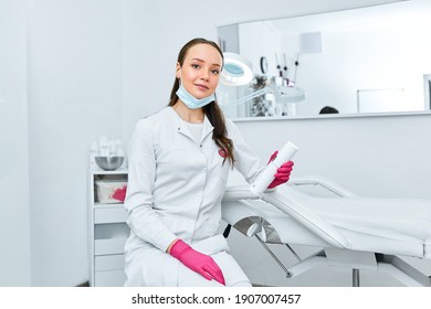 Portrait young beautiful cosmetologist in cosmetology cabinet. Beautiful caucasian woman on a cosmetology procedure. Wellness center. Healthcare, clinic, cosmetology