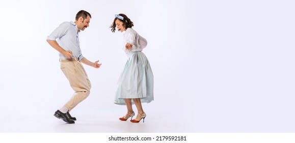 Portrait Of Young Beautiful Couple, Man And Woman, Dancing Retro Dance Isolated On White Background. Cheerful People. Concept Of Vintage Fashion, Hobby, Activity, Art, Music, Party, Creativity And Ad