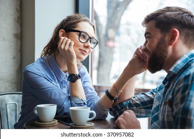 Portrait of young beautiful couple on a date drinking coffee in cafe 