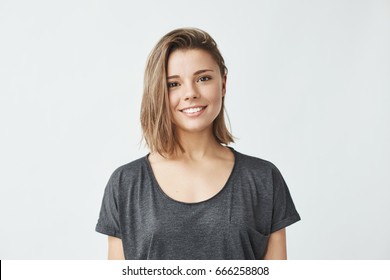 Portrait young beautiful cute cheerful girl smiling looking at camera over white background 