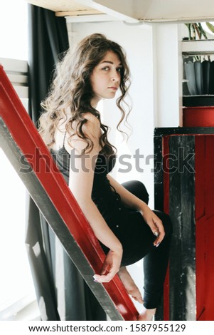 Similar – barefoot young woman sitting barefoot in a window frame