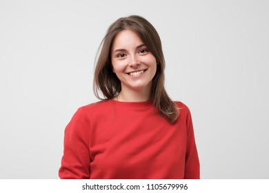 Portrait of young beautiful gcaucasian woman in red t-shirt cheerfuly smiling looking at camera. Studio photo isolated on white background. Copy space. - Shutterstock ID 1105679996