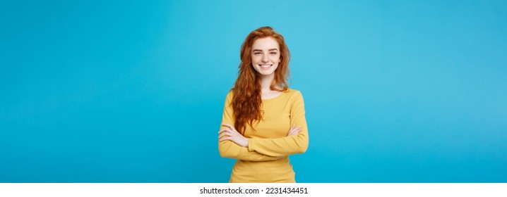 Portrait of young beautiful ginger woman with freckles cheerfuly smiling looking at camera. Isolated on pastel blue background. Copy space - Powered by Shutterstock