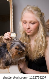 Portrait Of A Young Beautiful Girl With Blue Eyes And Blonde Hair Daydreaming In Her Boudoir 