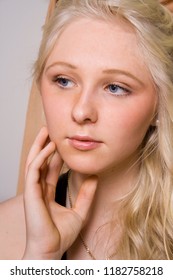 Portrait Of A Young Beautiful Girl With Blue Eyes And Blonde Hair Daydreaming In Her Boudoir 