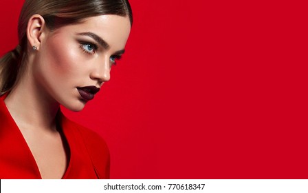 Portrait of a young beautiful girl close-up in the studio with burgundy lipstick.Fashion, beauty, make-up, cosmetics, hairstyle, beauty salon, boutique, discounts, sales.