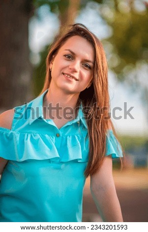 Portrait of a young beautiful girl in a summer park.