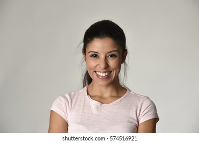 portrait of young beautiful and happy Latin woman with big toothy smile excited and cheerful in charming face expression isolated clear grey background in female happiness emotion
