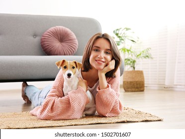 Portrait Of Young Beautiful Hipster Woman With Her Adorable Four Months Old Jack Russell Terrier Puppy At Home In Living Room Full Of Natural Sunlight. Lofty Interior Background, Close Up, Copy Space.