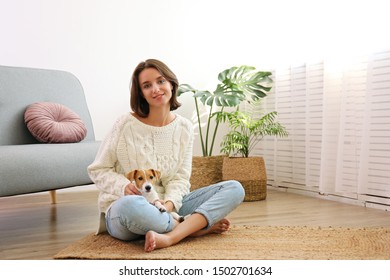 Portrait Of Young Beautiful Hipster Woman With Her Adorable Four Months Old Jack Russell Terrier Puppy At Home In Living Room Full Of Natural Sunlight. Lofty Interior Background, Close Up, Copy Space.