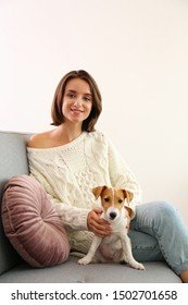 Portrait Of Young Beautiful Hipster Woman With Her Adorable Four Months Old Jack Russell Terrier Puppy At Home In Living Room Full Of Natural Sunlight. Lofty Interior Background, Close Up, Copy Space.