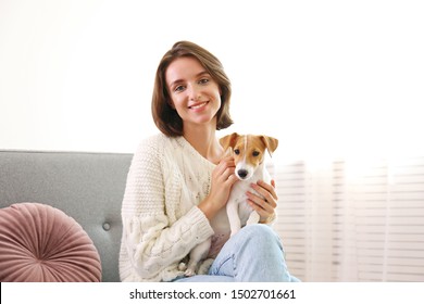 Portrait Of Young Beautiful Hipster Woman With Her Adorable Four Months Old Jack Russell Terrier Puppy At Home In Living Room Full Of Natural Sunlight. Lofty Interior Background, Close Up, Copy Space.