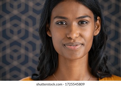 Portrait Of Young Beautiful Indian Woman Smiling And Looking At Camera. Close Up Face Of Happy Woman With Satisfaction In The Eyes. Middle Eastern Girl Standing On Pattern Background With Copy Space.