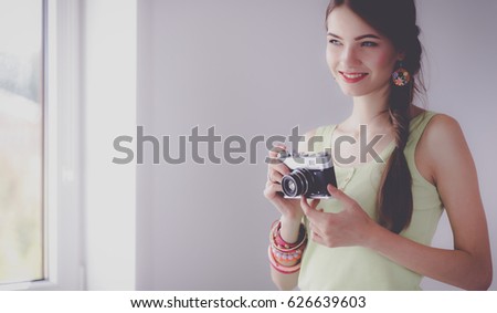 Portrait of a young beautiful photographer woman near table