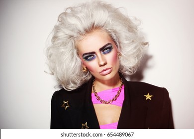 Portrait Of Young Beautiful Platinum Blond Woman With Bold Eyebrows And 80s Style Makeup