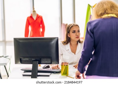 Portrait Of Young Beautiful Pretty Owner Business Woman Fashion Designer Stylish Sitting And Working.Attractive Senior Woman Designer Working With Laptop And Colorful Fabrics At Fashion Studio